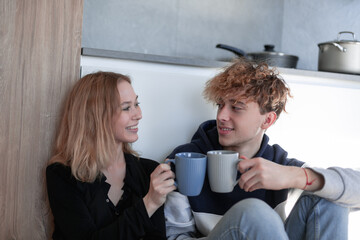 Couple looking at each other and smiling with cups