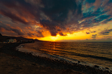 sunset on the canarian coast on a northern beach beautiful sky with clouds with beautiful shapes and beautiful with beautiful colors
