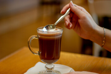 hand holding a cup of coffee