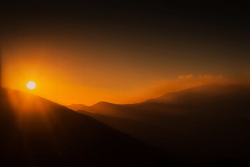 Fototapeta na wymiar Orange sunset at the Andes of Ecuador mountain range