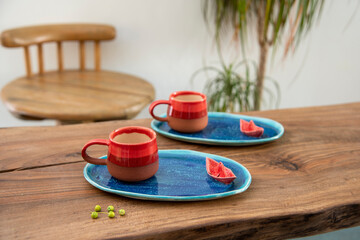 colorful handmade ceramic coffee cup on wooden table
