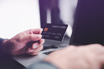 Hands holding credit card using Laptop payment shopping online with customer network connection via Omni channel system. Online shopping concept. people with technology.