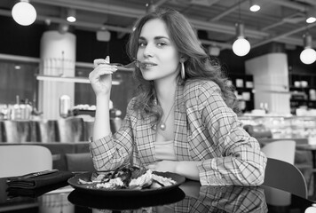 Young beautiful smiling woman eating healthy food