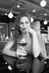 Elegant beautiful brunette woman with glass of red wine