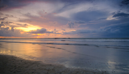 Fototapeta na wymiar Beautiful Sunset at Bali Beach featuring fisherman boat