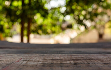 Naklejka na ściany i meble Empty wooden table in front of abstract blurred bokeh background