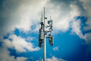 Telecommunication tower with 4G, 5G transmitters. Cellular base station with transmitter antennas...