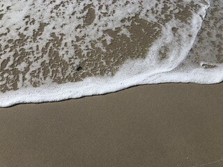 waves ocean foam on the beach