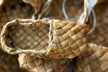 woven shoes made of wood bark from the master on the table