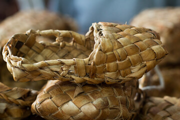 woven shoes made of wood bark from the master on the table