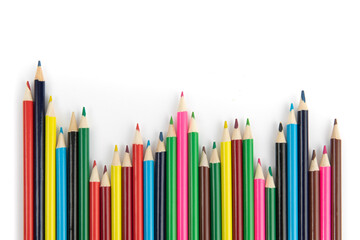 a row of colored pencils in a jagged arrangement like a graph isolated on white
