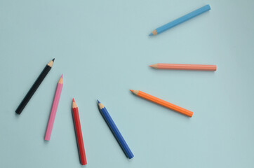 display of the empty space with colored pencils, the concept of colored pencils on a blue background
