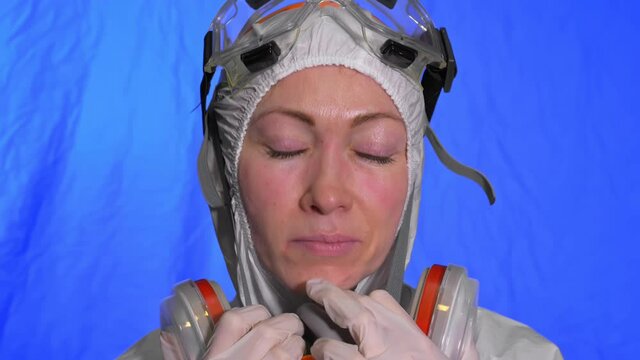 Scientist virologist in respirator. Slow motion. Woman close up look wearing protective medical mask. Concept health safety N1H1 virus protection coronavirus epidemic 2019 nCoV. Chroma key blue film.