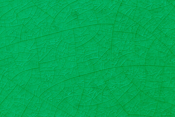 Green crack ceramic tile. Nature color of glazed tile texture abstract background. 