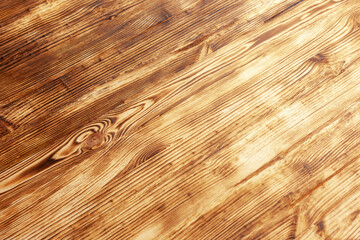 burnt brushed wooden surface is located diagonally, use as background or texture