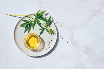 Medical marijuana cannabis cbd oil. CBD oil hemp products. Macro detail of dropper with CBD oil, cannabis live resin extraction on white background. Medical marijuana concept