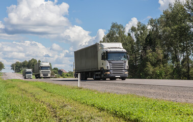 Truck convoy delivers goods on a country road