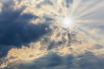 Naklejka na ściany i meble Heavenly landscape with the sun illuminating the clouds