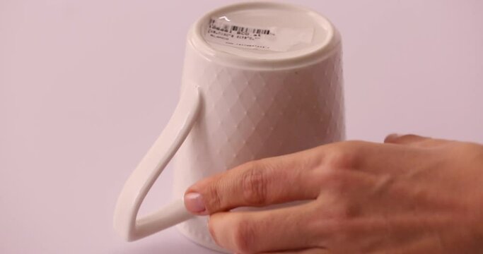 Life hack: struggling taking off a sticker, adding hot water to a white bowl to easily taking a sticker out 