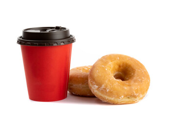 two honey glazed donuts stacked beside a red takeout coffee cup isolated on white
