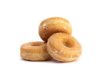 a pile of three sweet honey glazed donuts isolated on white