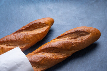 Two baguettes on the stone background, Bread that is long and hard