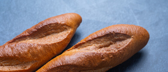 Two baguettes on the stone background, Bread that is long and hard