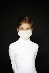 Boy in mask on black background