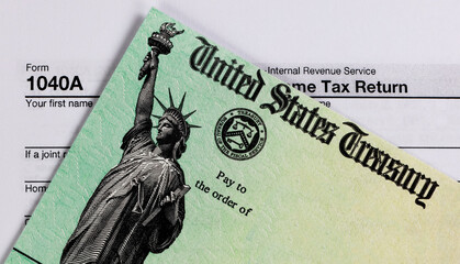 Refund check and tax form in close up view - 354477759