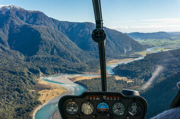 Helicopter window view of mountain valley with river
