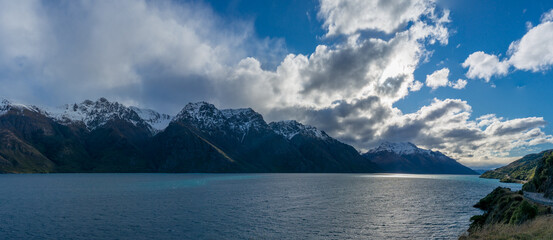 Mountain landscape with lake and snow-capped mountain peaks