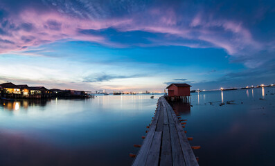 Wooden bridge Clan Tan Jetty view during sunrise in George Town, Penang