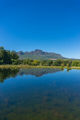 Countryside landscape with pond, lake and green grass