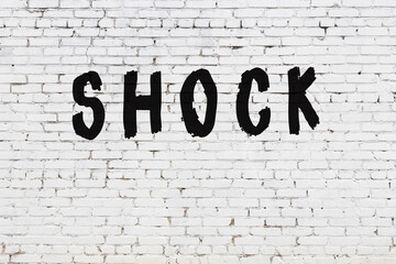Word shock painted on white brick wall - obrazy, fototapety, plakaty
