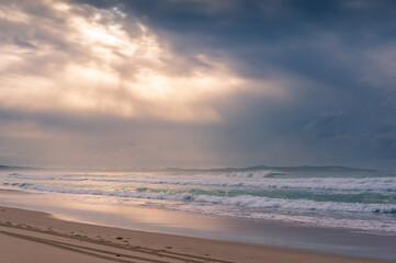 Fototapeta na wymiar Beach sunrise landscape with soft waves and beautiful sunlight