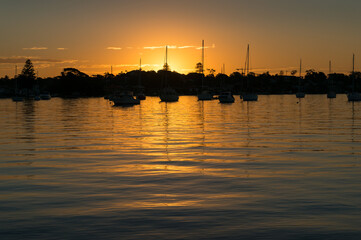 Fototapeta premium Sunset landscape with yachts in calm lagoon. Summer sunset landscape