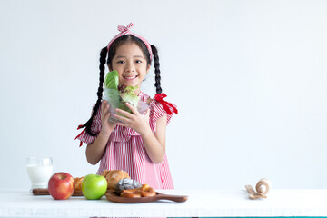 Cute Asian girl  holding salad bowl for breakfast, and smiling looking at camera
