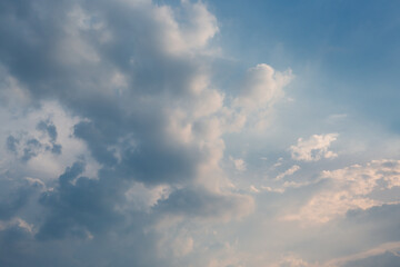 
Beautiful dramatic gray and white clouds on blue sky, variety of shapes, silhouettes and shades at sunset time