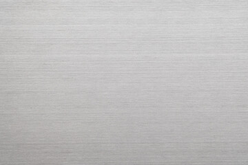 Abstract metal texture of brushed stainless steel plate with the reflection of light.