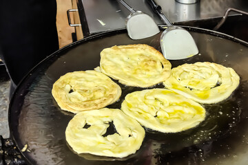Fried Roti on hot pan with boiling oil