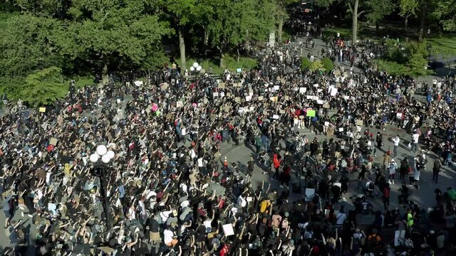 social justice activism in Washington Square Park - protestors with signs demonstrating following killing by 