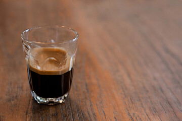 A cup of espresso coffee on wooden table