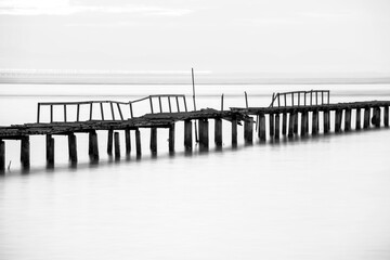 Long exposure view of wooden bridge in back and white background 