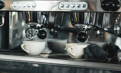 Professional coffee machine of silver metal with two coffee cups. Brewing fresh coffee at a cafe.Restaurant and hospitality industry