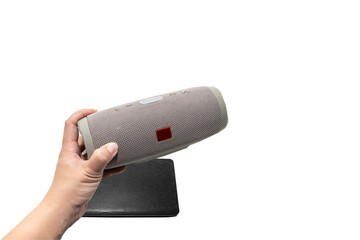 The speaker handle is connected to Bluetooth. To listen to favorite songs During the time of the holidays With a backup battery or power bank to charge On a white background.