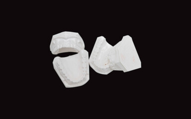 Blurry image,teeth model Is a tooth block made of cement For use in dental clinics Placed on a white background.