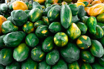 Pile of ripe papaya on fresh fruit market stall 