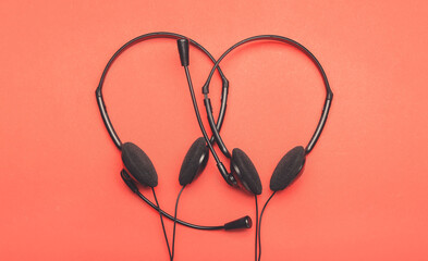 Modern headsets on color background