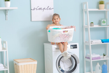 Little girl doing laundry at home