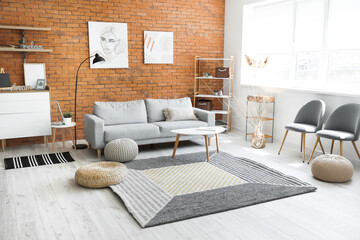 Stylish interior of living room with carpet and sofa